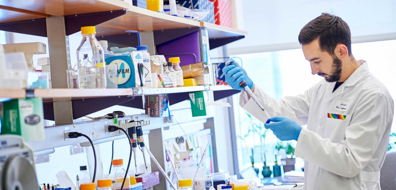 Scientist Works with Test Tubes in a Laboratory