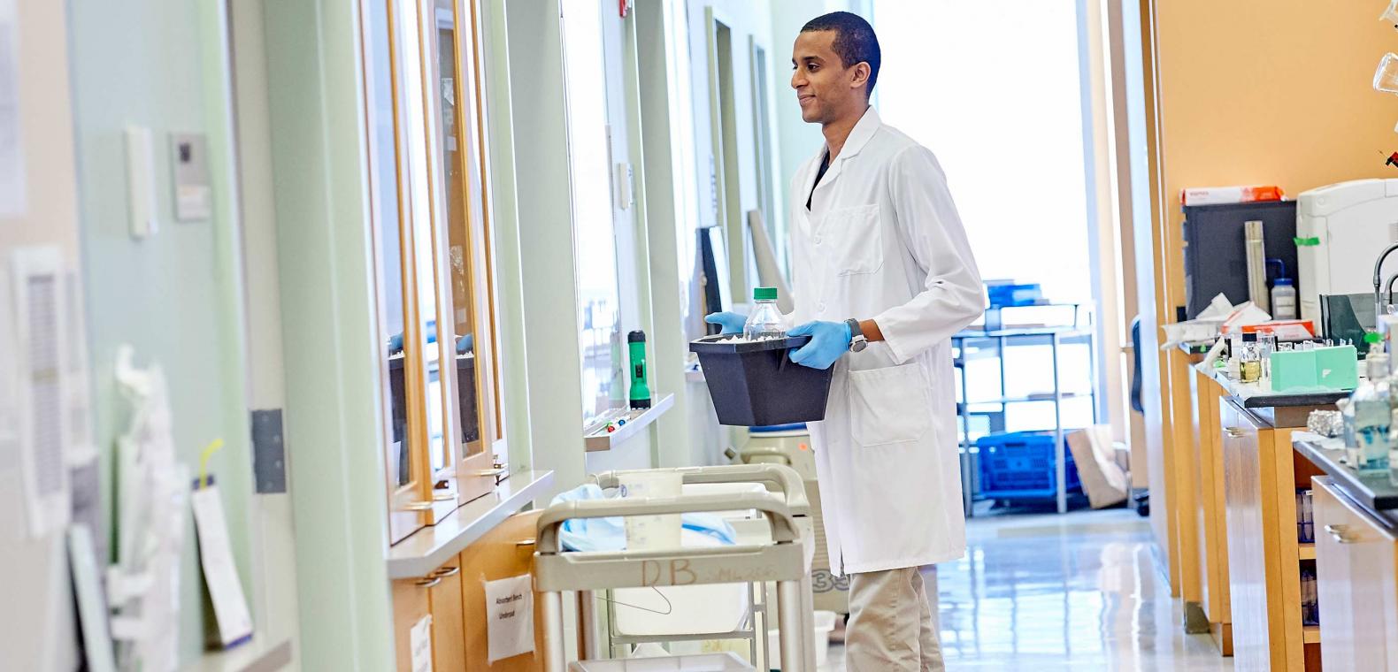 Scientist Carries Scientific Materials in a Laboratory