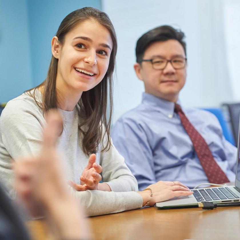 Colleagues Sit at a Desk