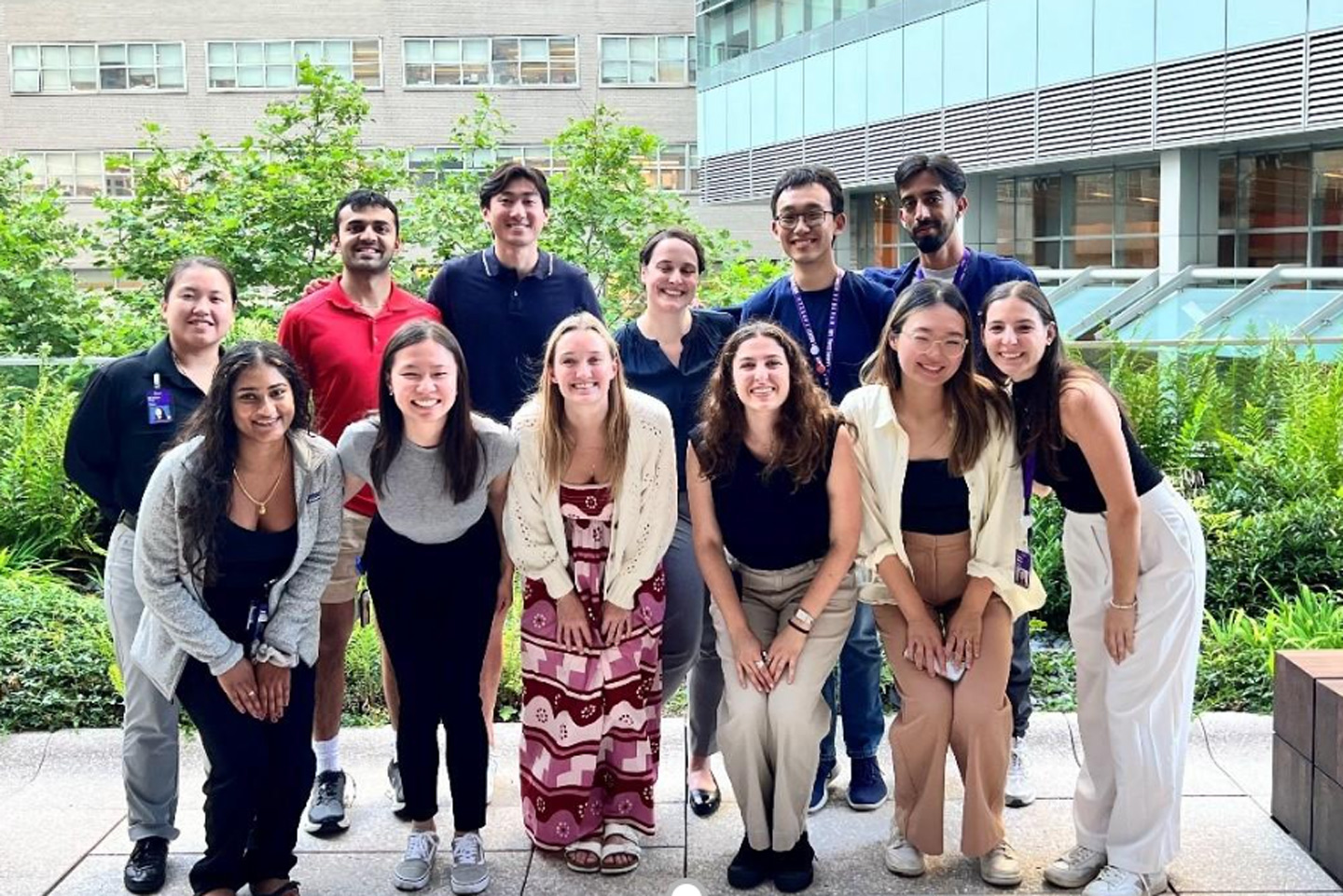 A smiling group of people outside