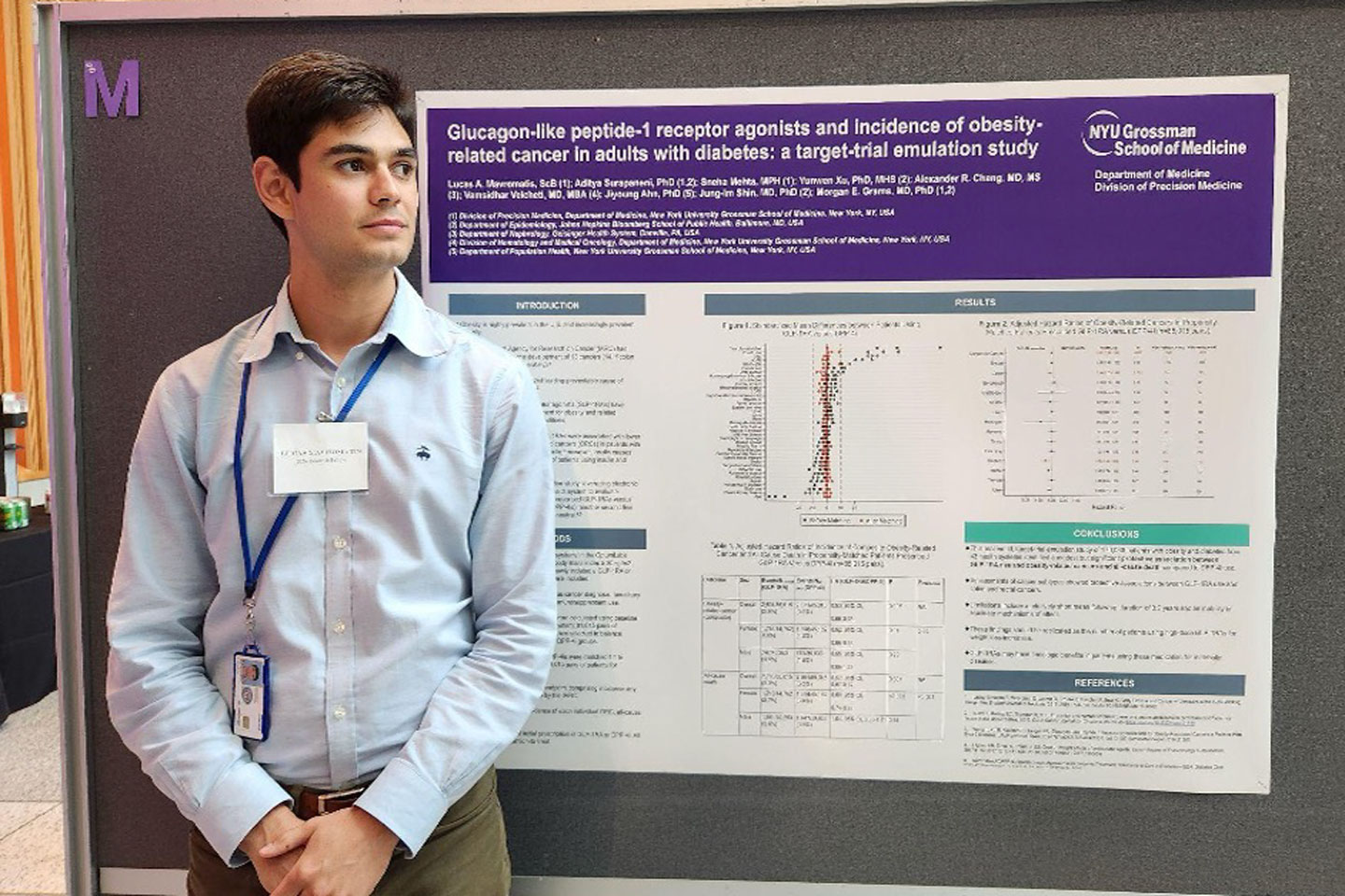 A young man stands in front of a research poster about glucagon-like peptide 1 receptor agonists and incidence of obesity-related cancer.