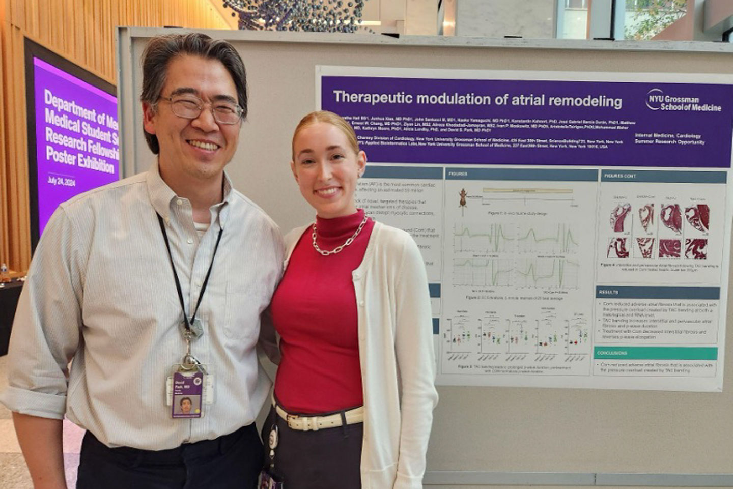 Two people smile in front of a research poster titled "Therapeutic modulation of atrial remodeling" at an NYU Grossman School of Medicine research exhibition.