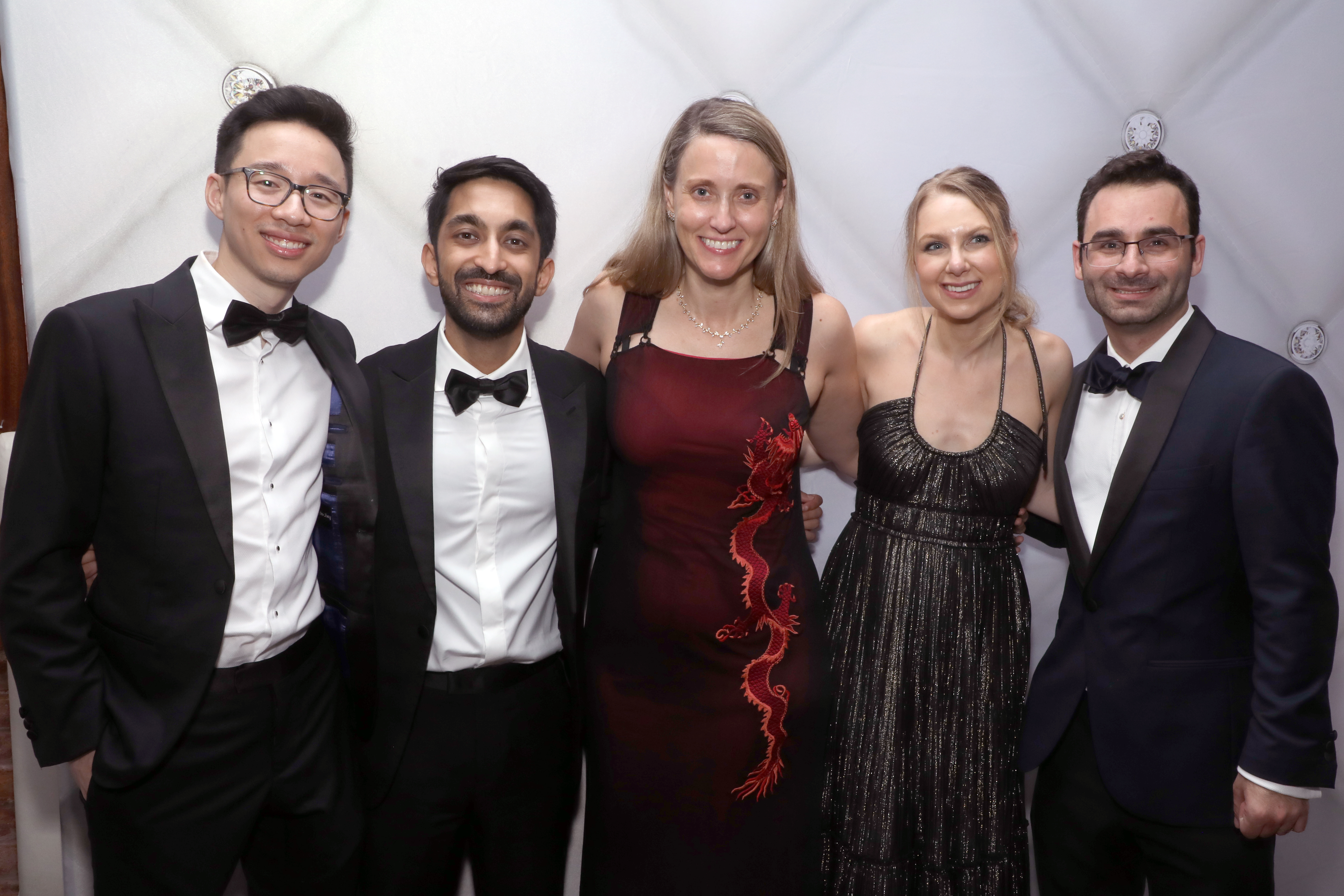 Group of well-dressed residents pose at a social event