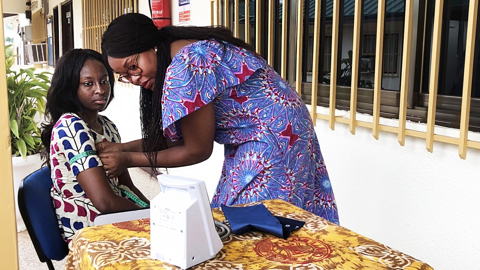 A Healthcare Worker Takes Blood Pressure