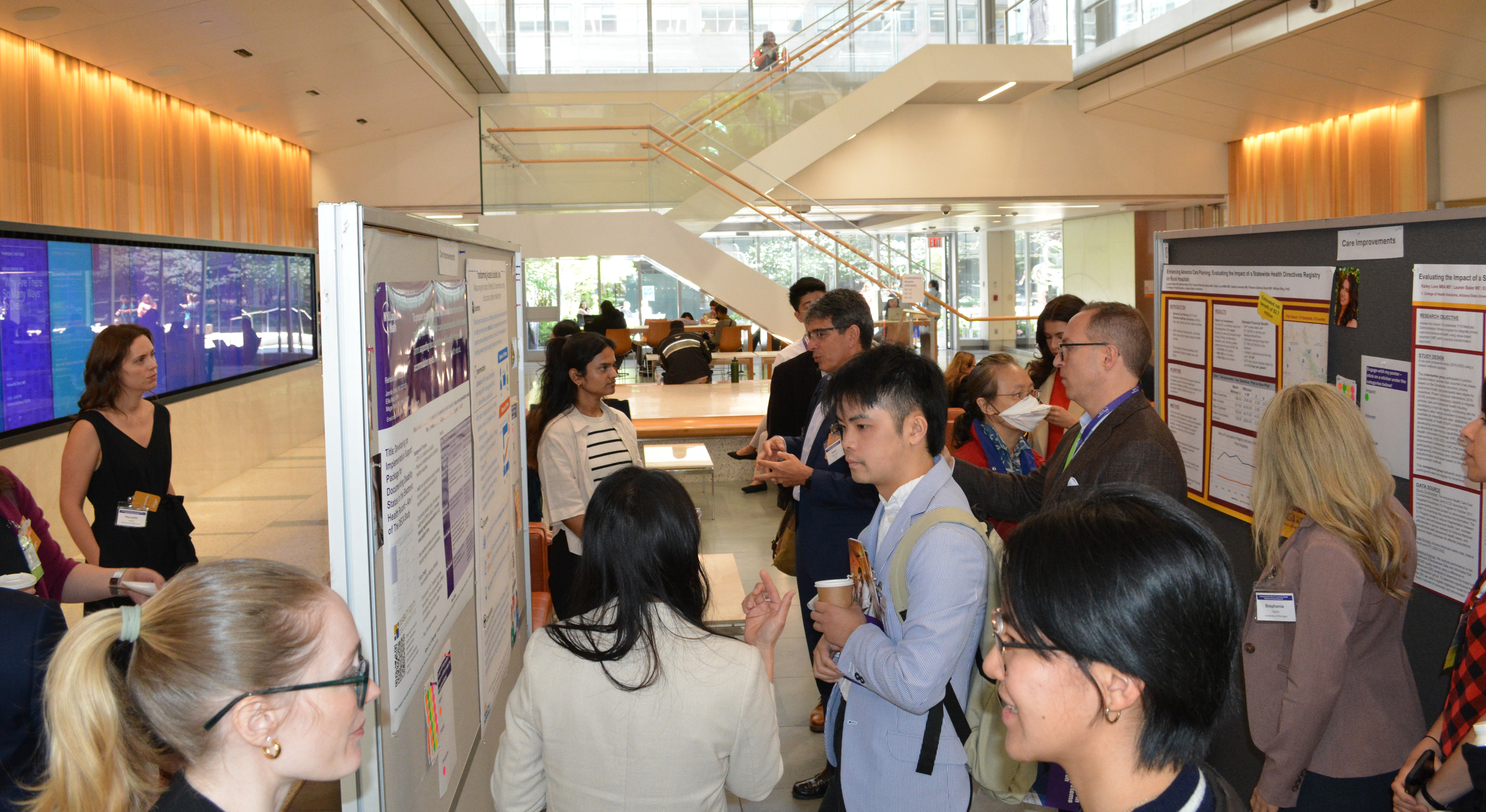 Attendees view posters at the 2025 Catalyzing Innovation in Learning Health Systems through Research Symposium.