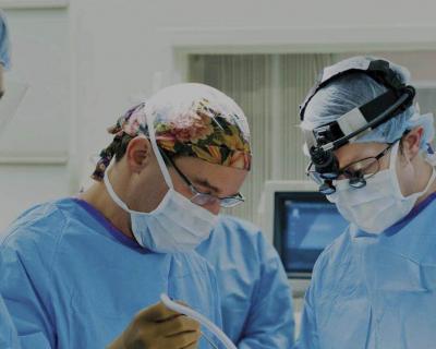 Three Surgeons Perform Procedure in Operating Room