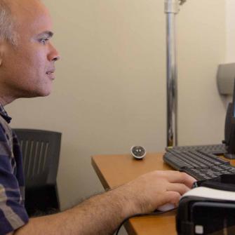 Staff Member at Institute for Innovations in Medical Education Watches a Video