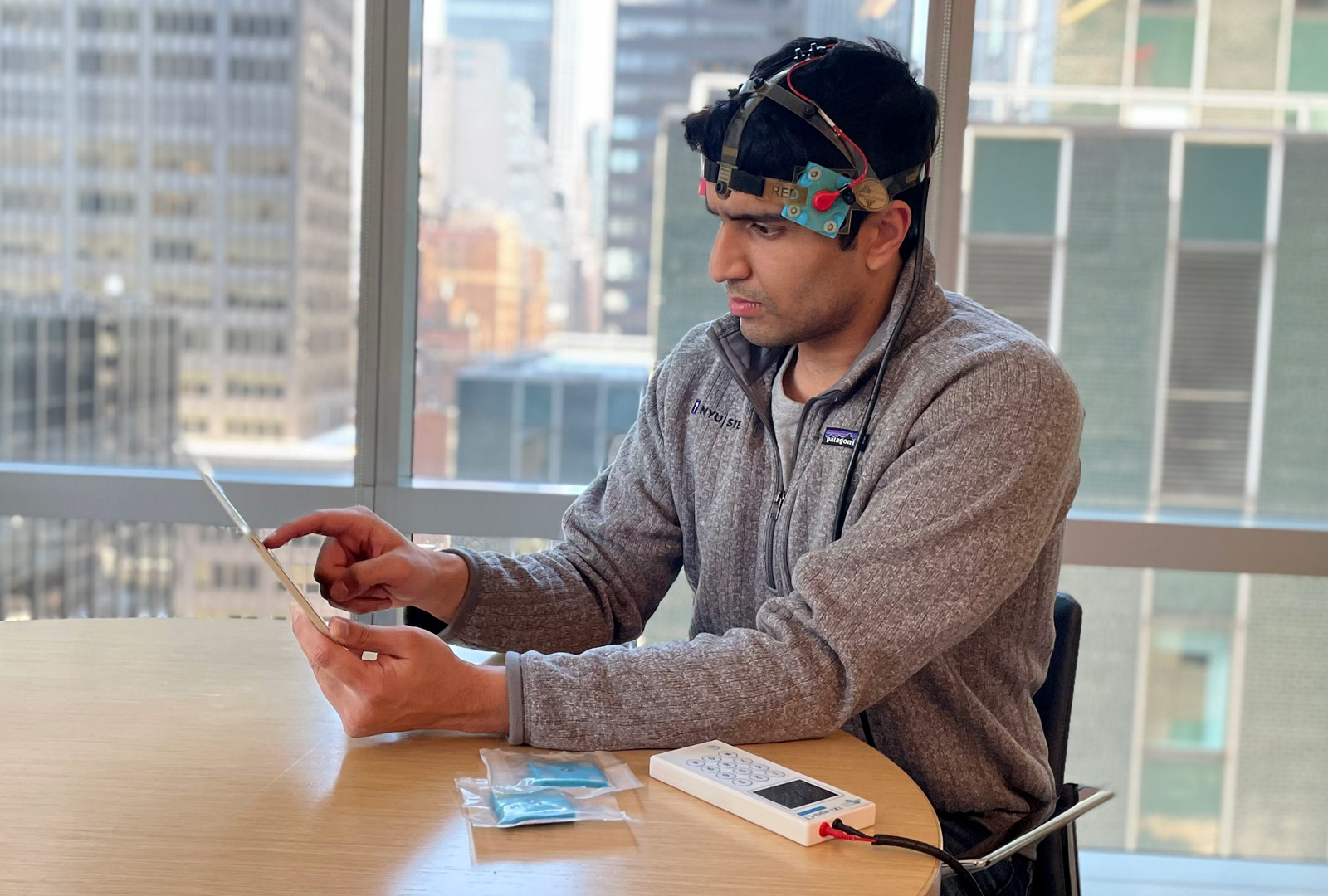 Woman wearing transcranial direct current stimulation headset