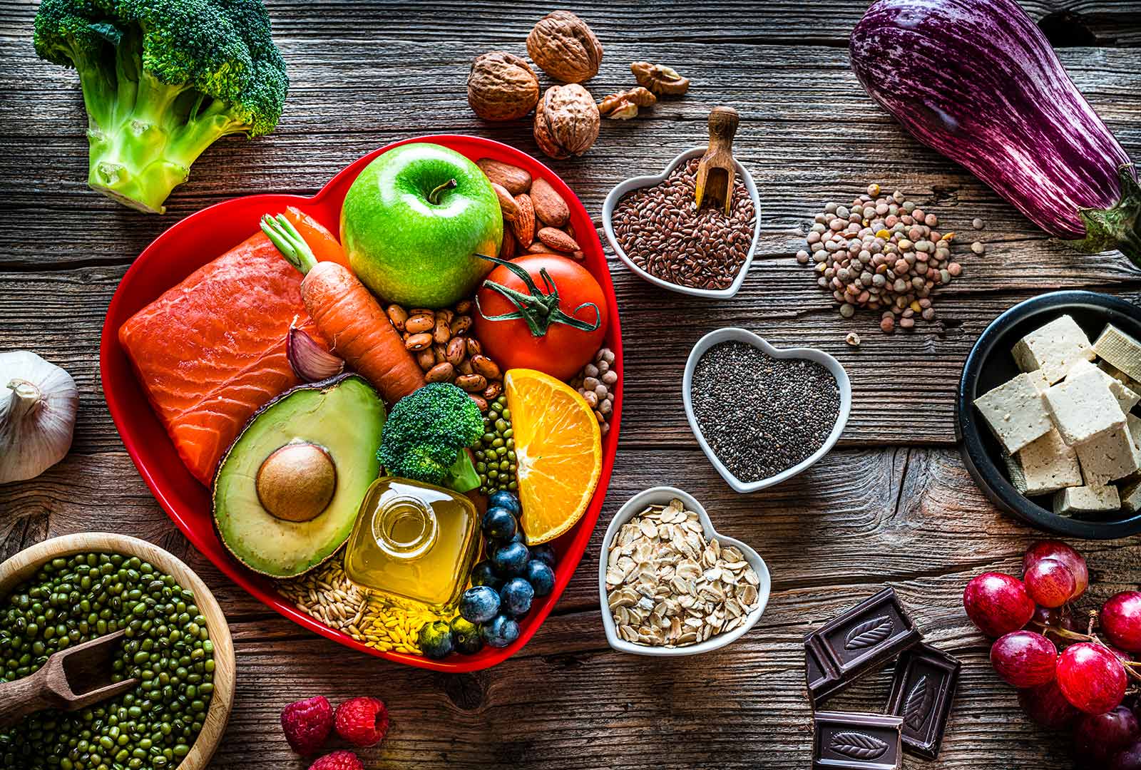 Heart-Healthy Foods Displayed in Heart-Shaped Bowls on a Wooden Table