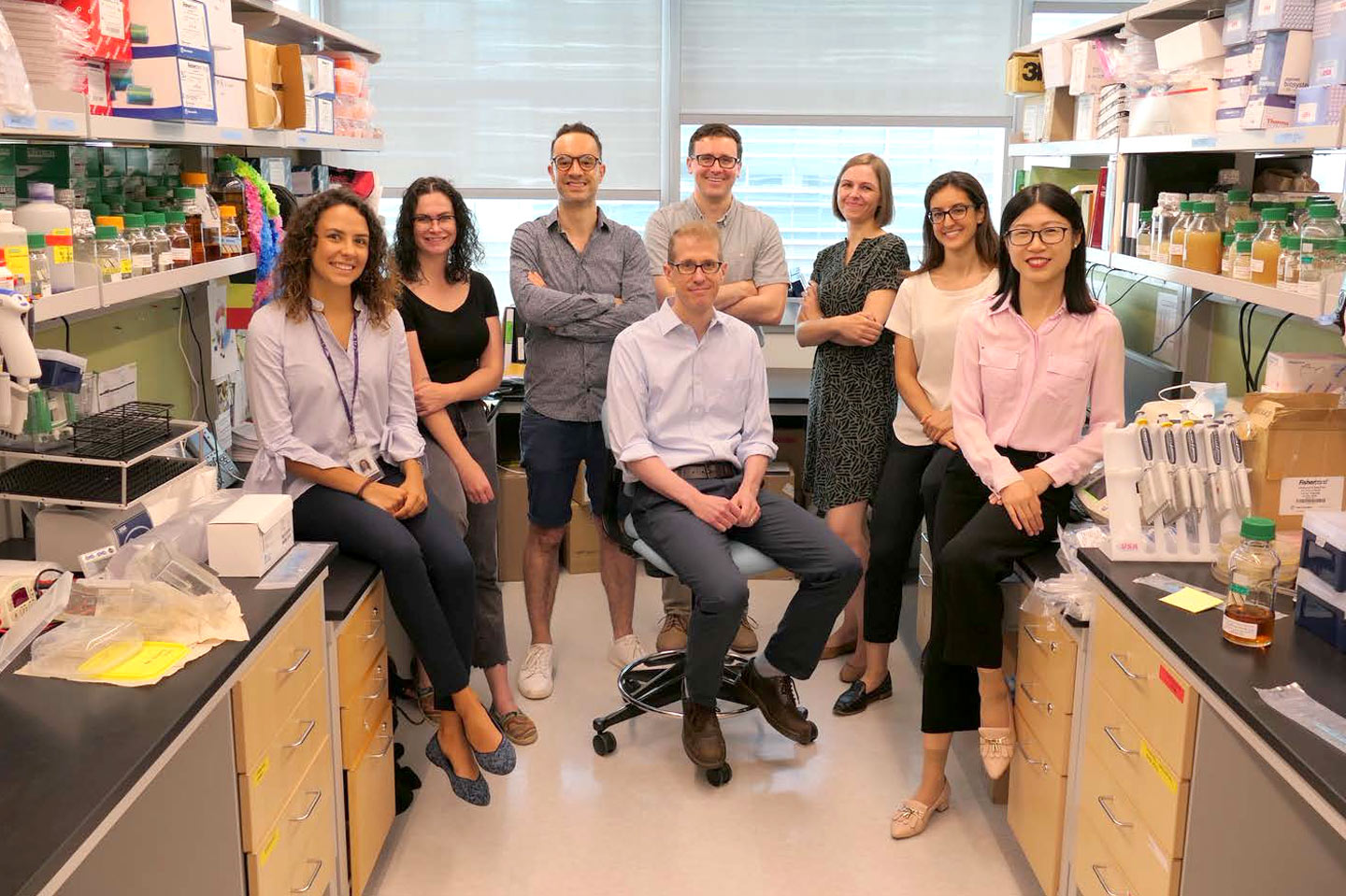 Members of the Shopsin Lab gather in a laboratory.