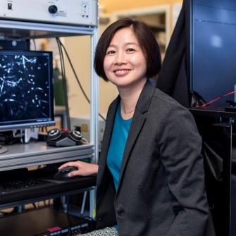 Dr. Guang Yang Sits in Research Lab