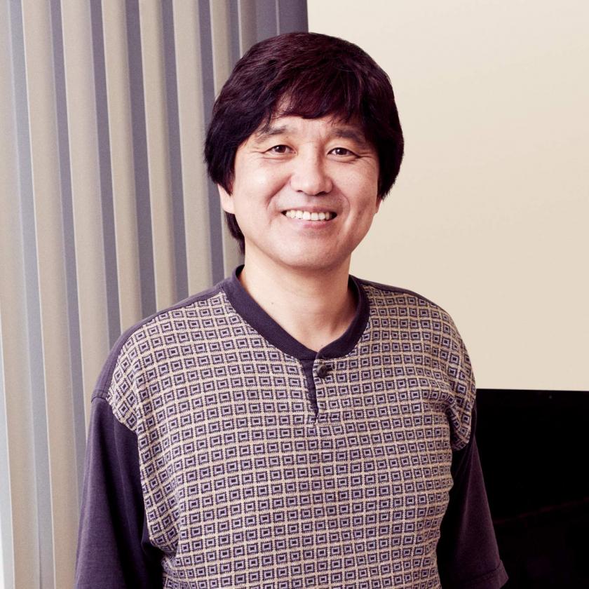 Molecular neurobiologist, Greg Suh, PhD, holds glass specimen slide